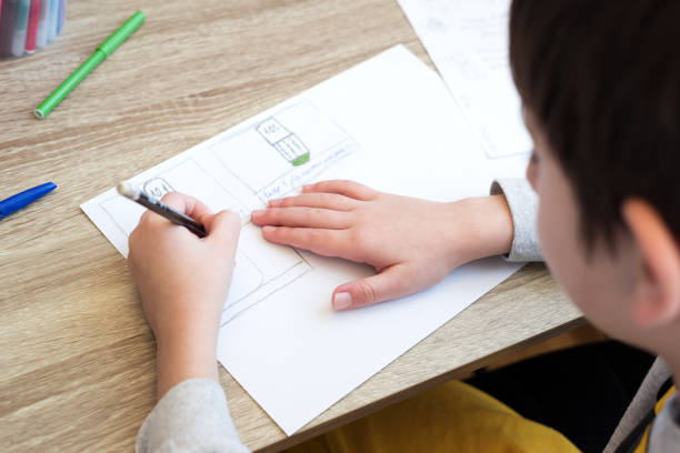 istock Close-up boy studying  and doing school homework. Distance learning online education or stay at home concept. Soft focus. 1217398864
