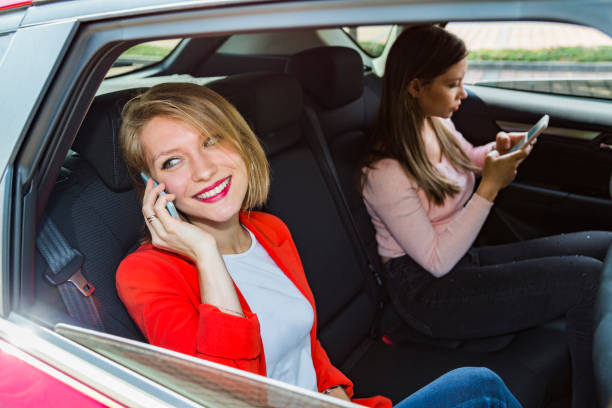 istock Girls in car talking on phone and sending message 1217399010