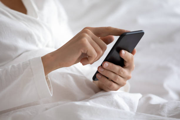 istock Close up focus on smartphone in female hands. 1217399837