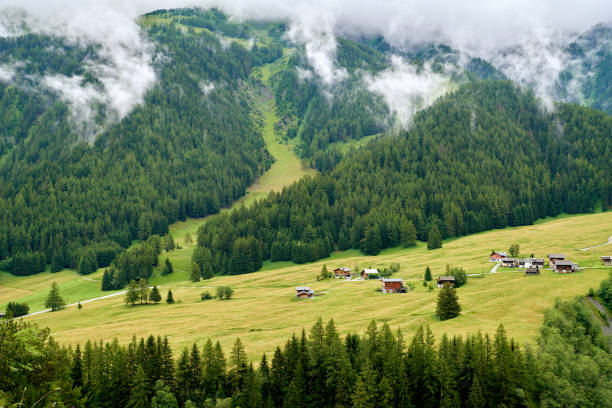 Beautiful village at Swiss alps valley at morning foggy.