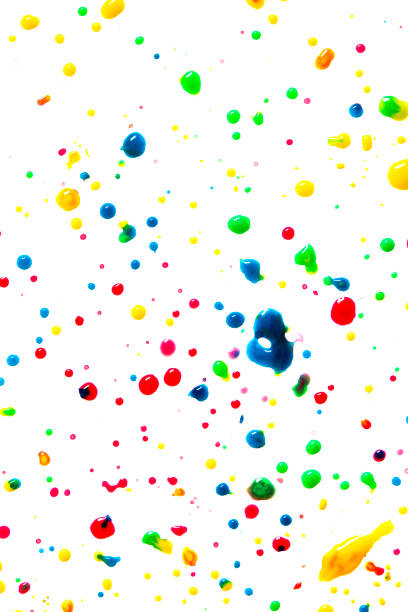 istock Close Up of Multicoloured Splattered Paint Blobs on White Paper for Abstract Background 1217406271