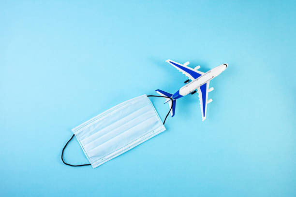 istock Model airplane with Protective medical mask. personal protective equipment. Self isolation 1217407566