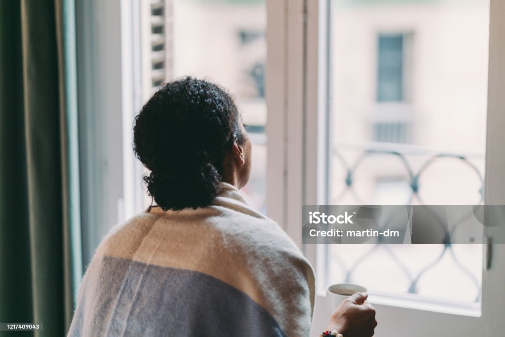 Staying home during COVID-19 pandemic Woman in quarantine staying home, drinking coffee feeling depressed Women Stock Photo