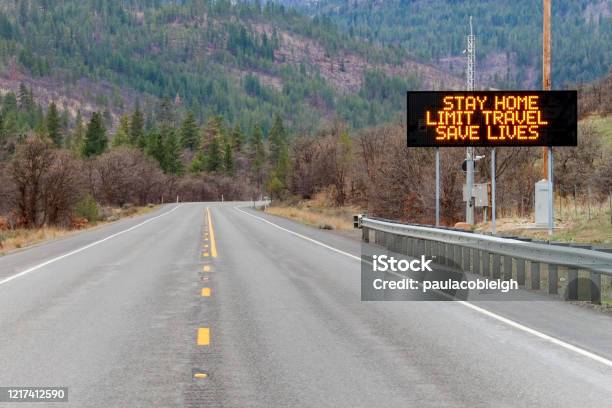 Electronic Sign Along Us Highway 97 Notifying People To Stay Home And Save Lives By Reducing The Risk Of Being Infected Due To Covid19 Stock Photo - Download Image Now