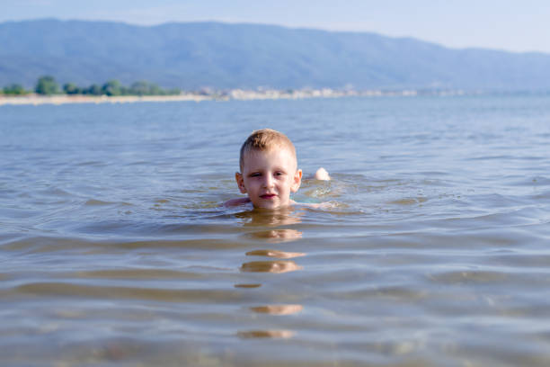 istock Boy is swimming in sea 1217413724