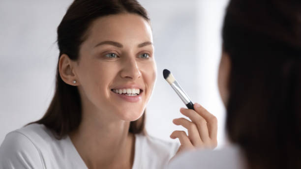 istock Beautiful young brunette woman doing make up in morning. 1217416350