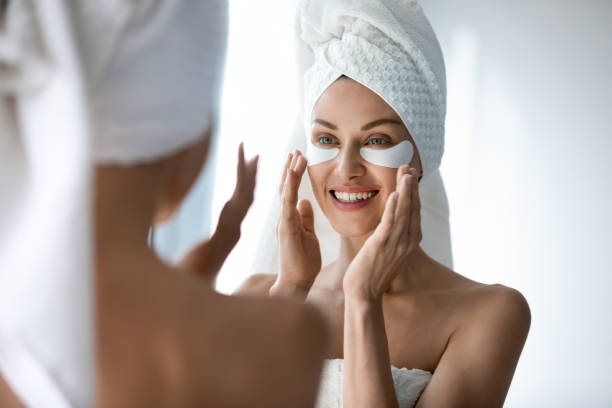 istock Smiling pretty woman applying hydrogel patches on under eye area. 1217416420