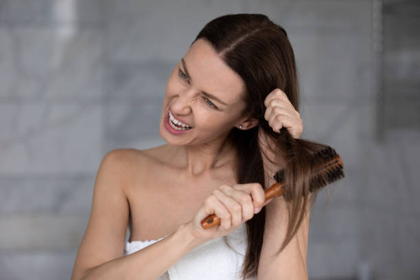 istock Angry lady suffering from problem with hair, styling in bathroom. 1217416447