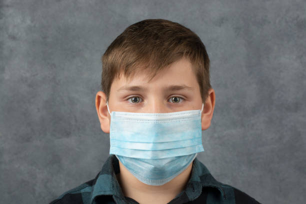 istock Boy in a medical mask. Virus protection. 1217416507