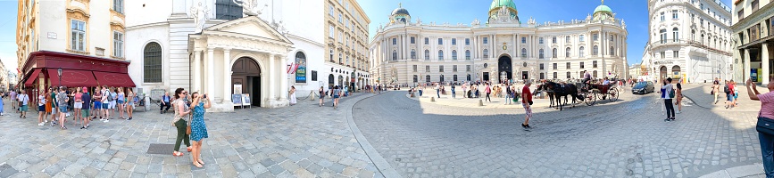 Vienna, Austria - July, 20 - 2019: View of the Michaelerplatz. The Michael facade is the north facade of the Hofburg in Vienna's 1st inner city district. The Michaelerplatz in front of it is considered one of the most beautiful squares in Vienna.