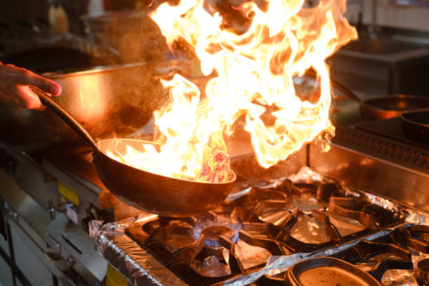 istock cooking with flame in a frying pan on a kitchen stove 1217420302