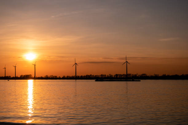 istock Moerdijk Netherlands, sunset winth windmills by the lake Vokerak river in Holland windmill energy sunset 1217422034