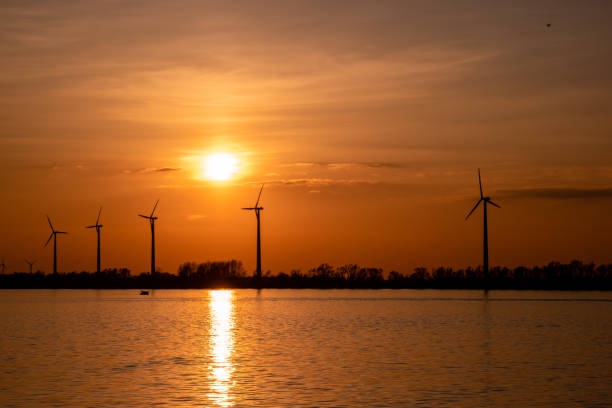istock Moerdijk Netherlands, sunset winth windmills by the lake Vokerak river in Holland windmill energy sunset 1217422152