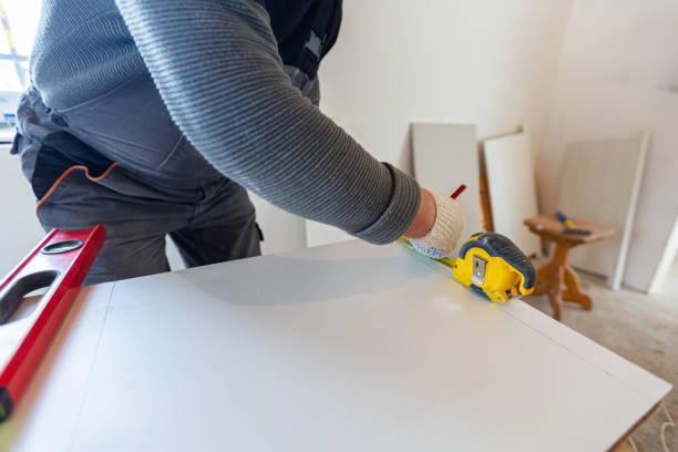 istock Worker is measuring the plastic detail before it cutting in apartment that is under construction, remodeling and reconstruction. Concept of total home improvement 1217422271