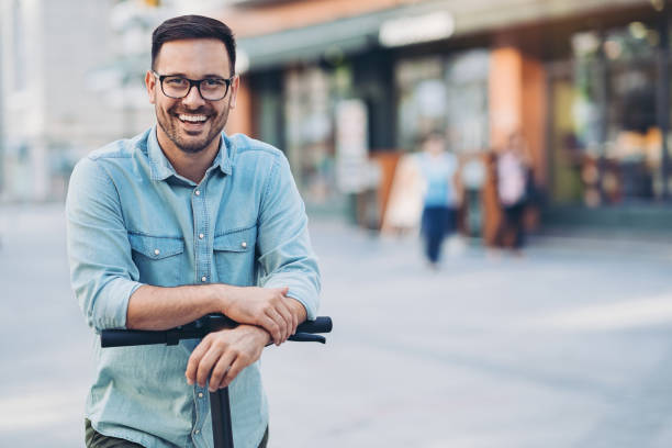 istock Portrait of a smiling man with an e-scooter 1217422324