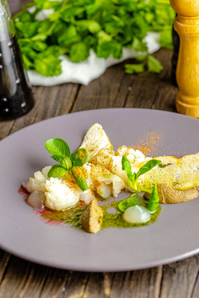 istock rustic wooden background, top and side, on a plate, halibut fish appetizer, olive tapenade, croutons, greens and vegetables 1217423865