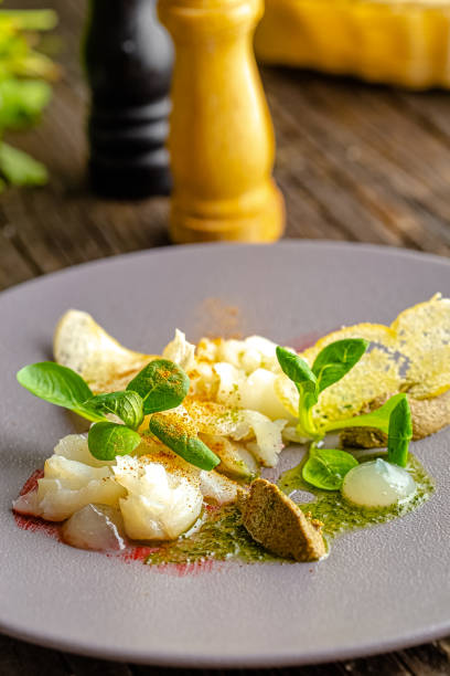 istock rustic wooden background, top and side, on a plate, halibut fish appetizer, olive tapenade, croutons, greens and vegetables 1217423867