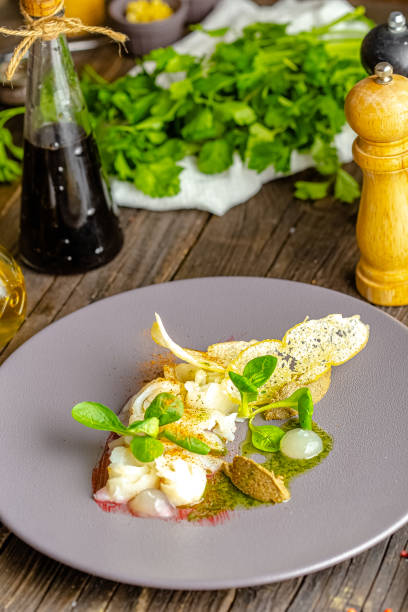 istock rustic wooden background, top and side, on a plate, halibut fish appetizer, olive tapenade, croutons, greens and vegetables 1217423886