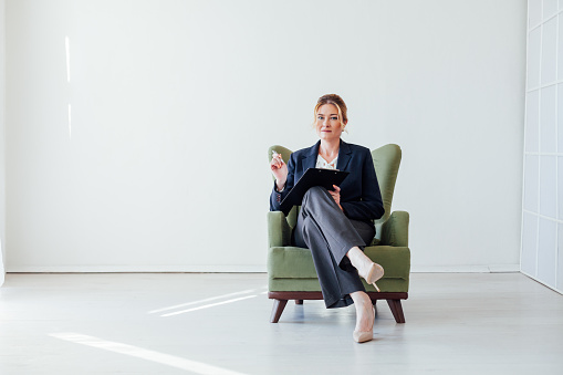woman psychologist at work in green chair