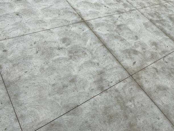 istock Concrete slabs of pavement, creating abstract, grunge, grey background pattern 1217425003