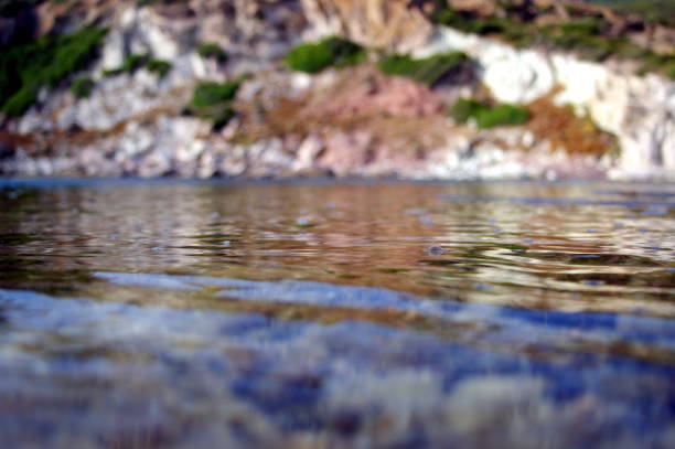 Seascape with rocks on the background of water. Sudak, Crimea