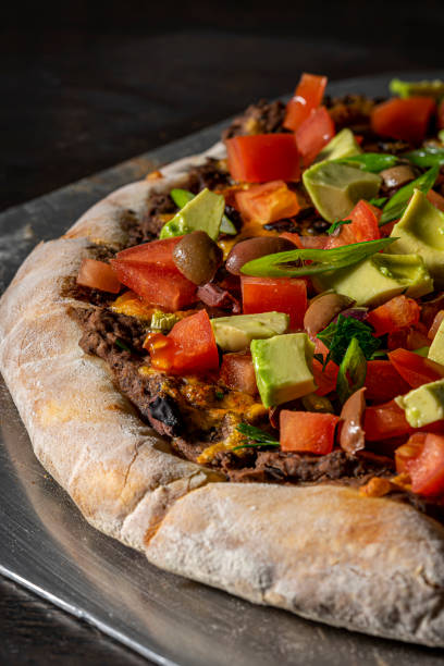 istock Taco pizza with fresh tomatoes and avocado. 1217427675