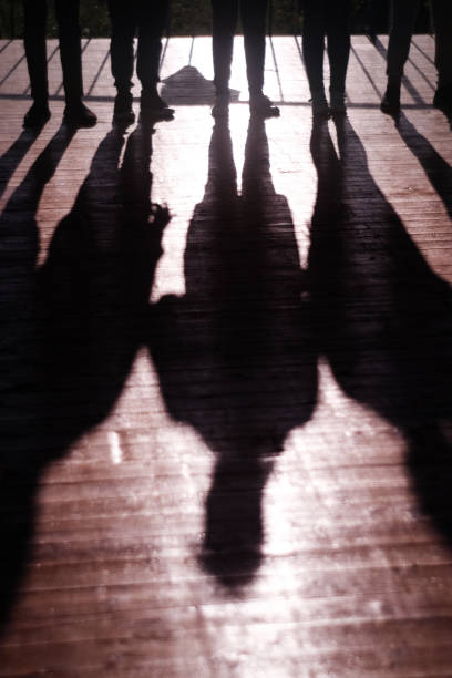istock The game is teamwork. Shadows people holding hands follow each other developing team spirit 1217429039