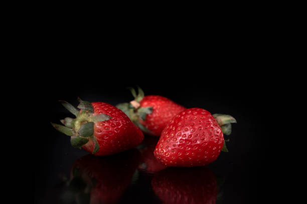 istock red fresh beautiful strawberry isolated on black background with soft light with empty place for text 1217429041