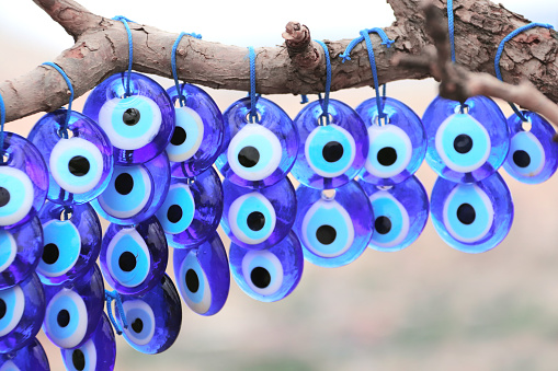 Many glass mascots - evil eye charms hang from a tree in Pigeon valley, Cappadocia,Turkey
