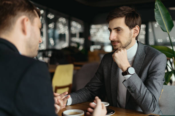 istock Two young businessmen discussing something 1217431263