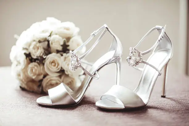 Photo of A pair of high heels and a wedding bouquet