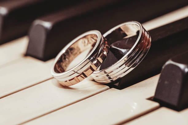 Two wedding rings on piano keys.