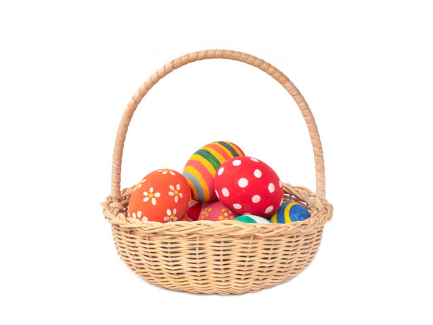 istock Painted easter eggs in the woven basket on white background. 1217434870