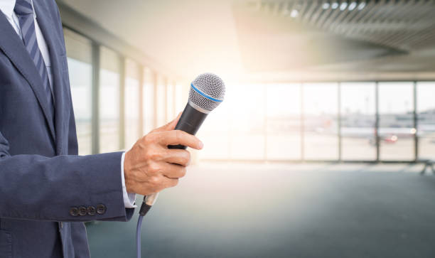 istock Unknow reporter hand holding microphone with copy space 1217436401