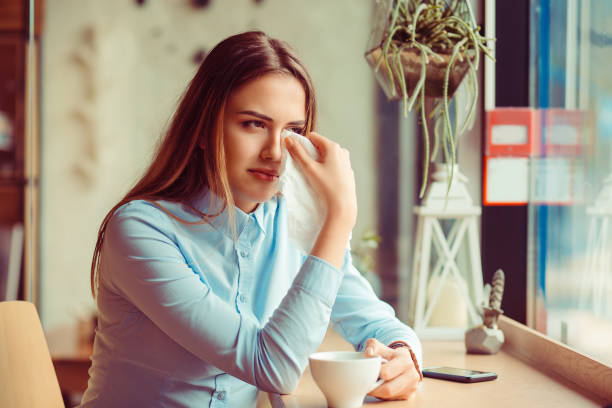 Misery, infelicity. Brunette woman girl about to cry wiping tears sneezing in a tissue drinking tea, coffee, hot beverage. Negative human emotion, face expression, reaction, body language Misery, infelicity. Brunette woman girl about to cry wiping tears sneezing in a tissue drinking tea, coffee, hot beverage. Negative human emotion, face expression, reaction, body language wiping tears stock pictures, royalty-free photos & images