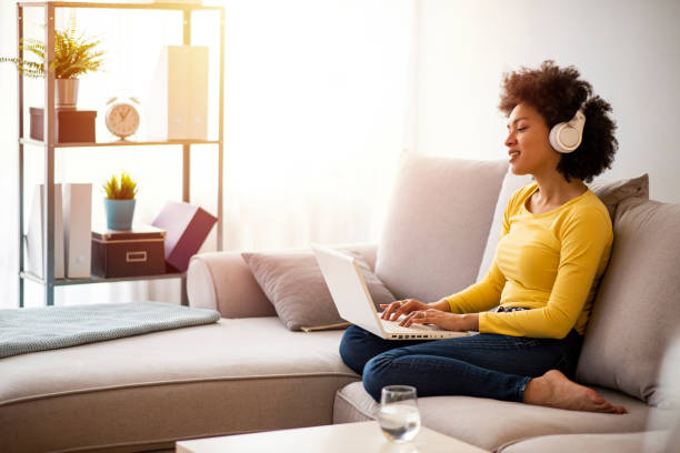 African woman working from home at the computer during self-isolation and quarantin