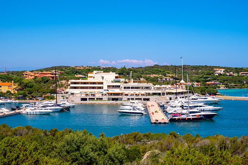 Porto Cervo, Sardinia / Italy - 2019/07/20: Panoramic view of luxury yacht port and docking facilities in Porto Cervo resort at the Sardinia coast of Tyrrhenian Sea