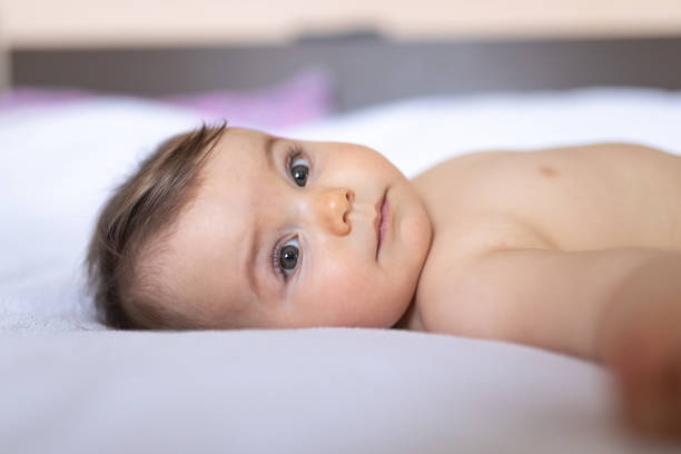 istock Baby girl laying on her bed 1217439078
