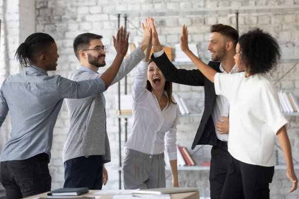 istock Excited successful multiracial business people giving high five, celebrating win. 1217439297