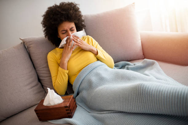 istock Sick Woman With Runny Nose Lying in Bed 1217439312