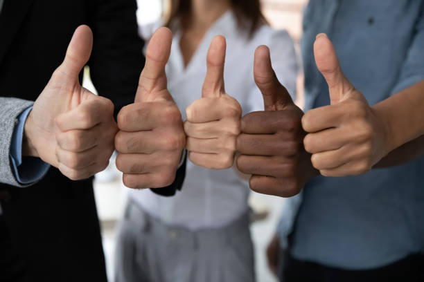 Diverse business team people hands showing thumbs up. Close up view of diverse business team people hands showing thumbs up like finger gesture recommendation or good job choice. Professional multicultural team recommend corporate service. thumbs up photos stock pictures, royalty-free photos & images