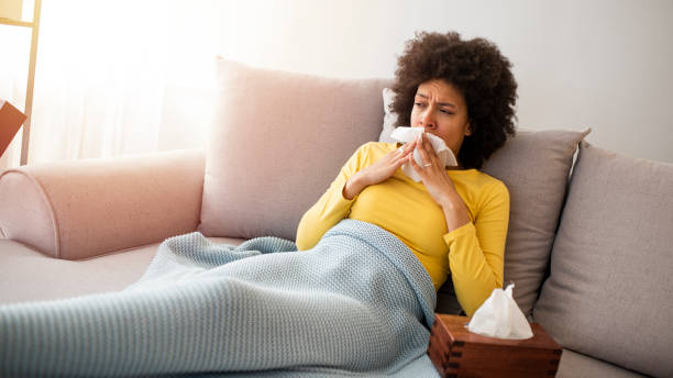 istock Sick Woman With Runny Nose Lying in Bed 1217439390
