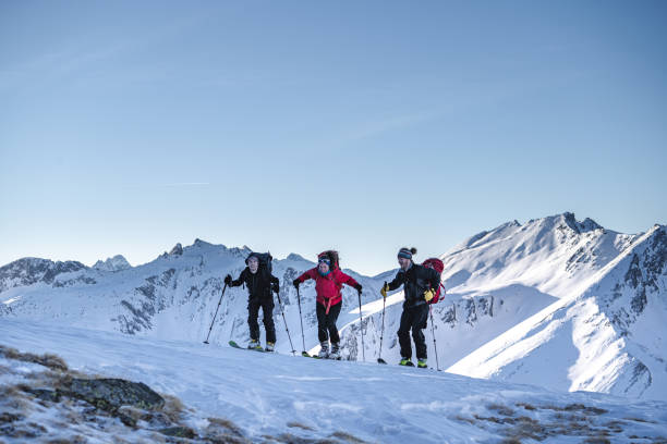 istock Backcountry skiers ascend mountain 1217439411