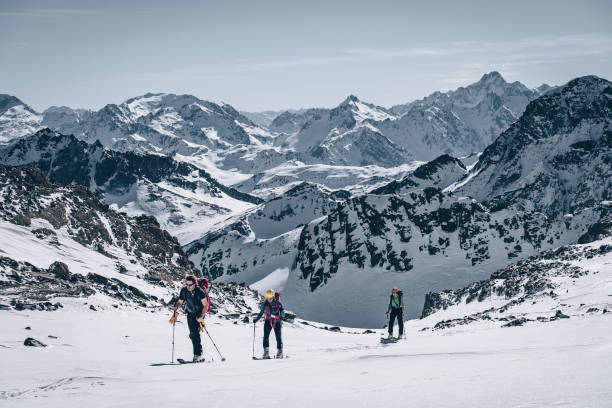 istock Backcountry skiers ascend mountain 1217439958