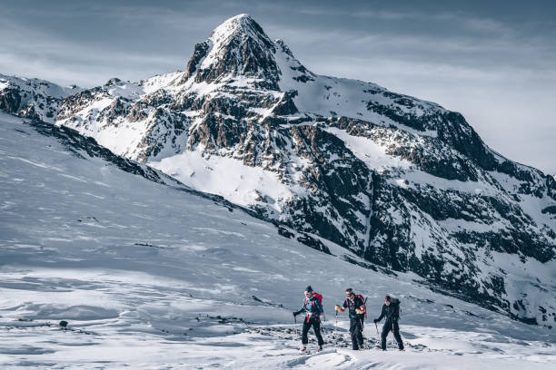 istock Backcountry skiers ascend mountain 1217440100