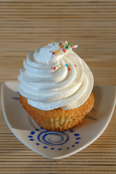 istock Gourmet Cupcake with White Creamy and Sprinkles 1217440478