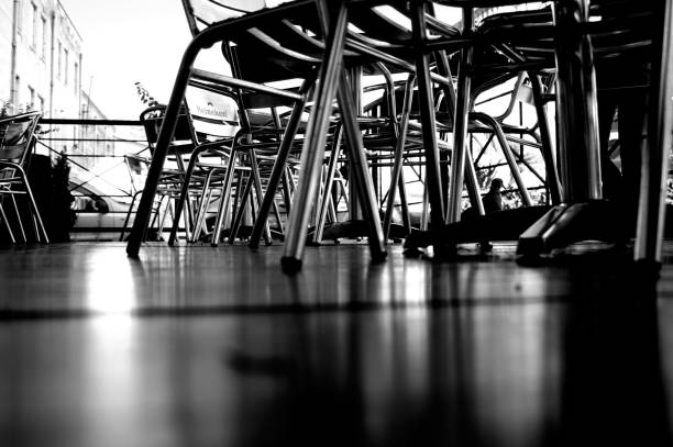 Two chairs and a table with daffosils on it outside an Italian restaurant - center of Milan
