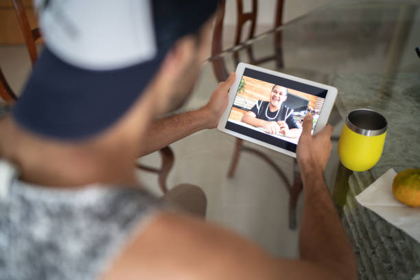 istock Man on a video conferencing with a woman at home 1217441748