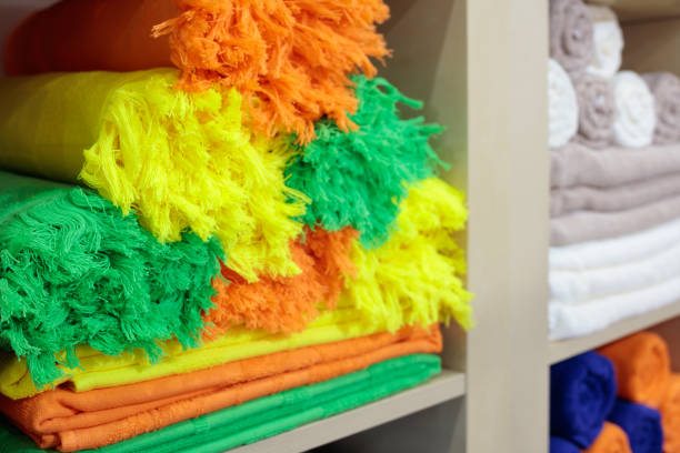 Colorful fresh Hotel Towels Folded and Stacked on a Shelf