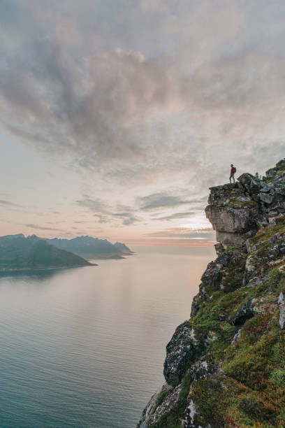 istock Man walking near  mountain on Senja island 1217443253